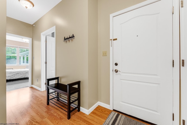 foyer featuring light wood-style floors and baseboards