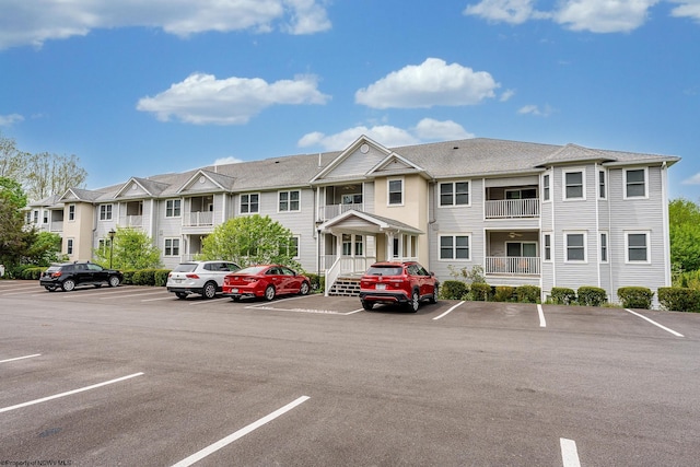 view of property with uncovered parking and a residential view