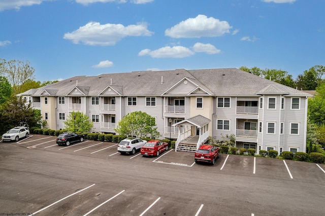 view of building exterior featuring uncovered parking