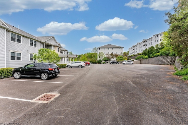 uncovered parking lot with a residential view
