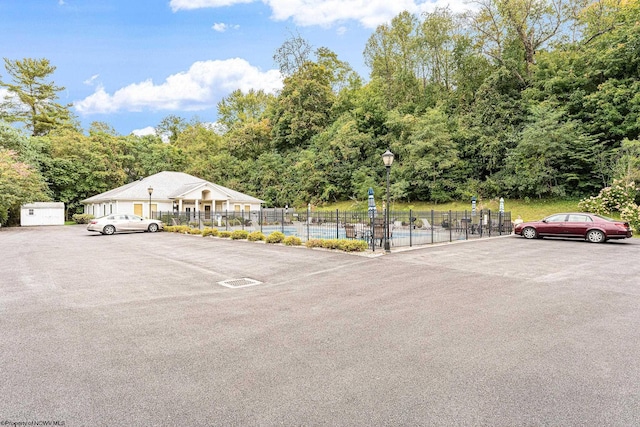 uncovered parking lot featuring fence