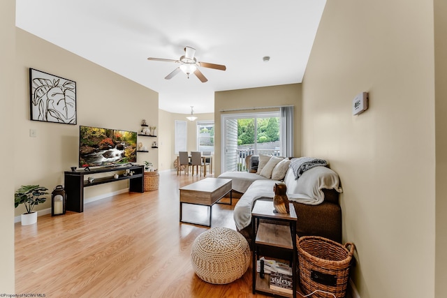living room featuring a ceiling fan, wood finished floors, and baseboards