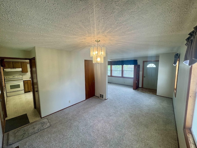 213 Albright Rd, Kingwood, WV 26537 - unfurnished room with a chandelier, light carpet, and a textured ceiling