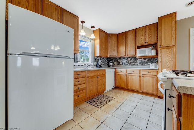 kitchen with white appliances, light countertops, tasteful backsplash, light tile patterned floors, and pendant lighting