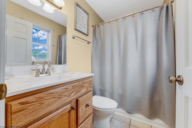 bathroom with tile patterned floors, vanity, toilet, and shower / bath combo with shower curtain