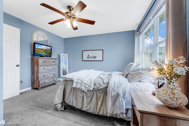 bedroom with carpet floors, baseboards, and a ceiling fan
