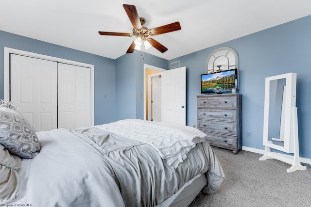 carpeted bedroom with a closet, baseboards, and a ceiling fan
