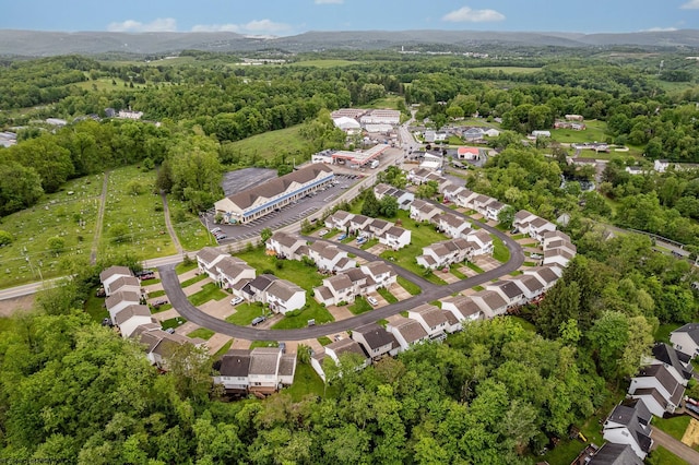 aerial overview of property's location with a heavily wooded area