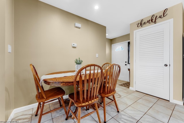dining area with light tile patterned floors, baseboards, and recessed lighting