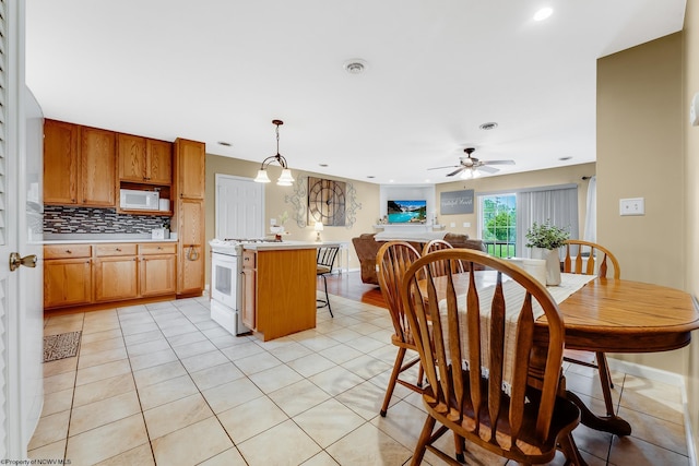 dining space featuring a ceiling fan, recessed lighting, and light tile patterned flooring