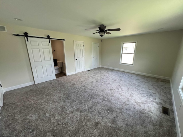 107 Valley Ct, Elkins, WV 26241 - unfurnished bedroom featuring a barn door, carpet flooring, baseboards, and ceiling fan