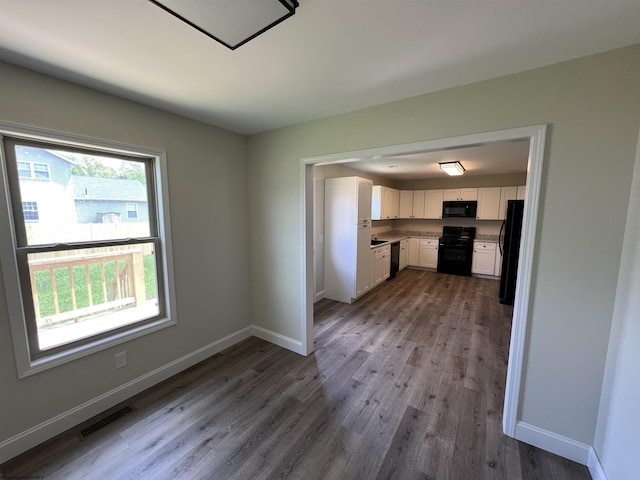 107 Valley Ct, Elkins, WV 26241 - kitchen with black appliances, white cabinetry, wood finished floors, and baseboards