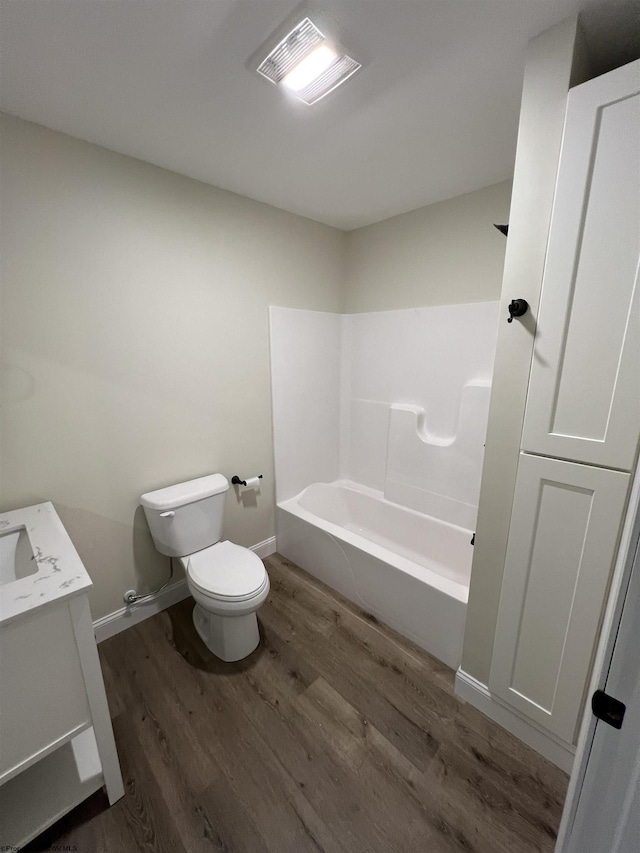 107 Valley Ct, Elkins, WV 26241 - bathroom with toilet, vanity, wood finished floors, washtub / shower combination, and baseboards