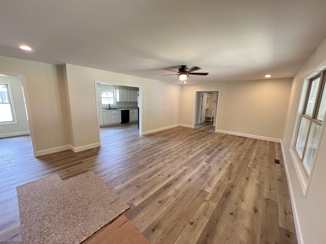 107 Valley Ct, Elkins, WV 26241 - unfurnished living room with wood finished floors, a ceiling fan, recessed lighting, a sink, and baseboards