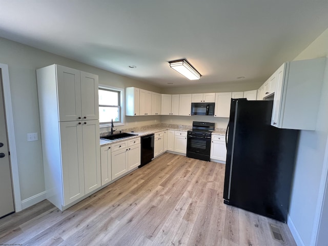 107 Valley Ct, Elkins, WV 26241 - kitchen featuring black appliances, a sink, light wood-style floors, light countertops, and baseboards