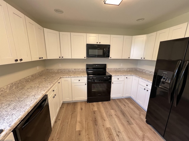 107 Valley Ct, Elkins, WV 26241 - kitchen featuring black appliances, white cabinets, light wood-style floors, light stone counters, and recessed lighting