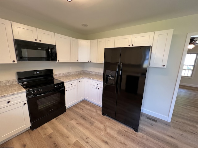 107 Valley Ct, Elkins, WV 26241 - kitchen with black appliances, light wood-style floors, white cabinets, and baseboards