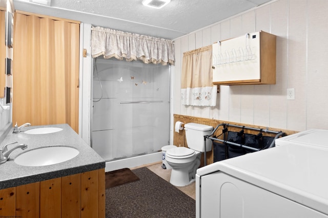 107 Orchard St, Masontown, WV 26542 - full bathroom featuring a shower stall, washing machine and clothes dryer, toilet, double vanity, and a textured ceiling