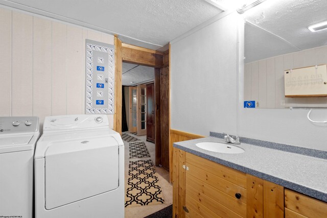 107 Orchard St, Masontown, WV 26542 - washroom featuring washing machine and clothes dryer, a textured ceiling, and wooden walls