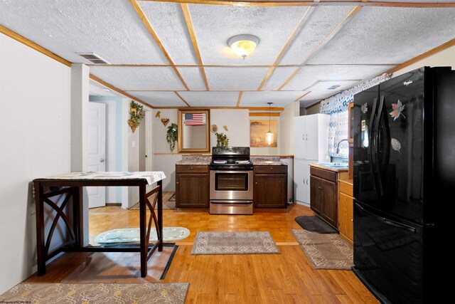 107 Orchard St, Masontown, WV 26542 - kitchen featuring freestanding refrigerator, electric stove, light wood-style floors, light countertops, and a sink