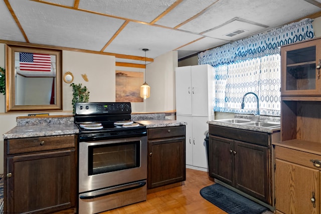 107 Orchard St, Masontown, WV 26542 - kitchen with electric stove, a sink, dark brown cabinets, light countertops, and hanging light fixtures
