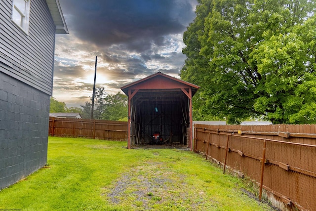 107 Orchard St, Masontown, WV 26542 - yard at dusk with an outbuilding and a carport