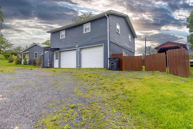 107 Orchard St, Masontown, WV 26542 - view of property exterior featuring an attached garage, fence, and driveway