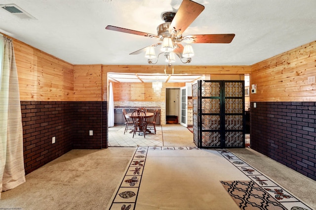 107 Orchard St, Masontown, WV 26542 - interior space featuring brick wall, wood walls, and ceiling fan