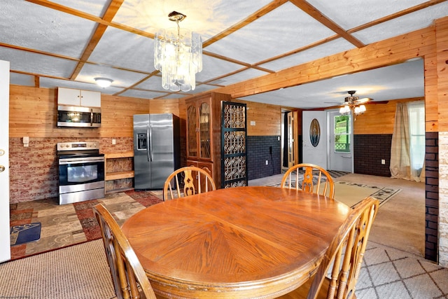107 Orchard St, Masontown, WV 26542 - dining space with wooden walls, a ceiling fan, carpet, and a chandelier