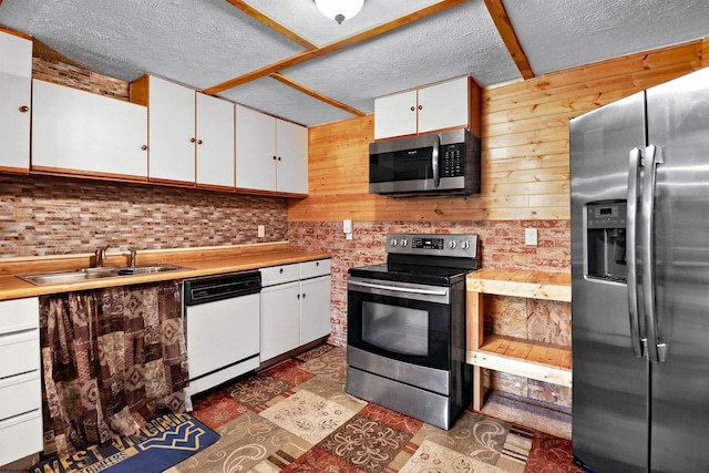 107 Orchard St, Masontown, WV 26542 - kitchen featuring appliances with stainless steel finishes, a sink, white cabinets, a textured ceiling, and light countertops