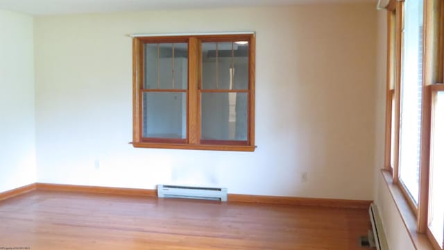 1782 Parsons Rd, Montrose, WV 26283 - empty room featuring a baseboard heating unit, plenty of natural light, and light wood-style flooring