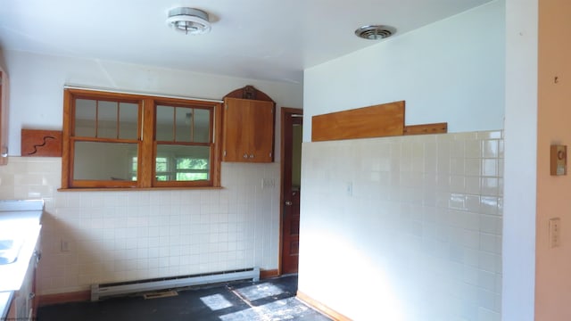 1782 Parsons Rd, Montrose, WV 26283 - kitchen featuring a baseboard heating unit, tile walls, brown cabinetry, and glass insert cabinets