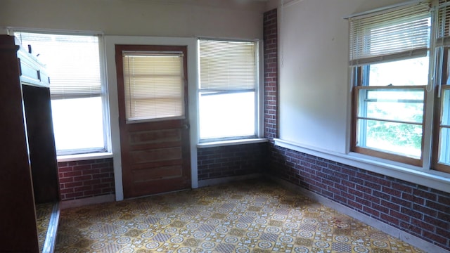 1782 Parsons Rd, Montrose, WV 26283 - empty room featuring brick wall and plenty of natural light