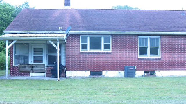 1782 Parsons Rd, Montrose, WV 26283 - view of home's exterior with a shingled roof, a yard, central AC unit, and brick siding