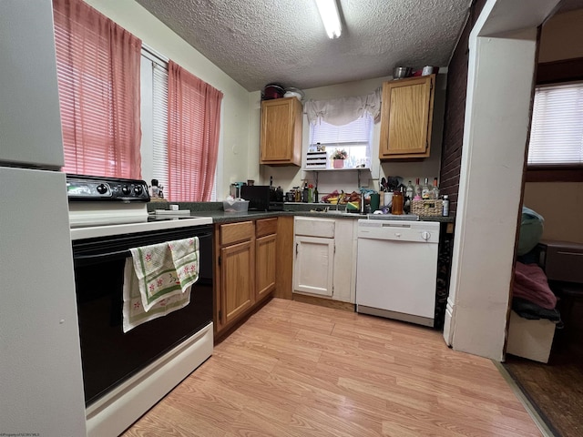 374 Forest Ave Unit 3, Morgantown, WV 26505 - kitchen with white appliances, a textured ceiling, light wood-style flooring, dark countertops, and a sink