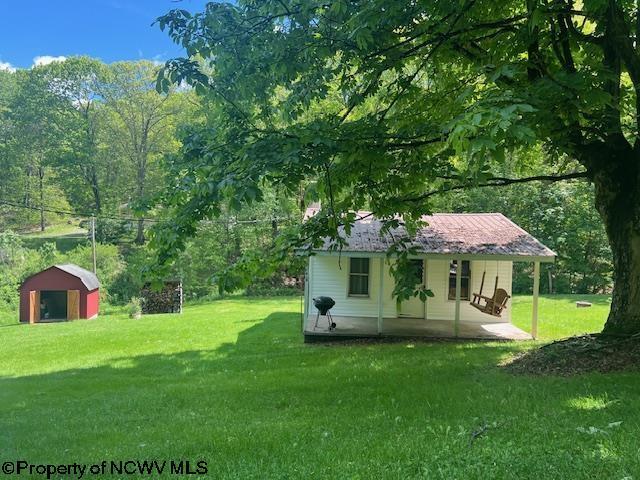 6142 Kanetown Rd, Tunnelton, WV 26444 - view of green lawn with an outdoor structure and a shed