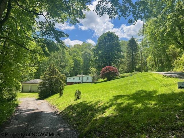 6142 Kanetown Rd, Tunnelton, WV 26444 - view of community with a yard, a wooded view, and a garage