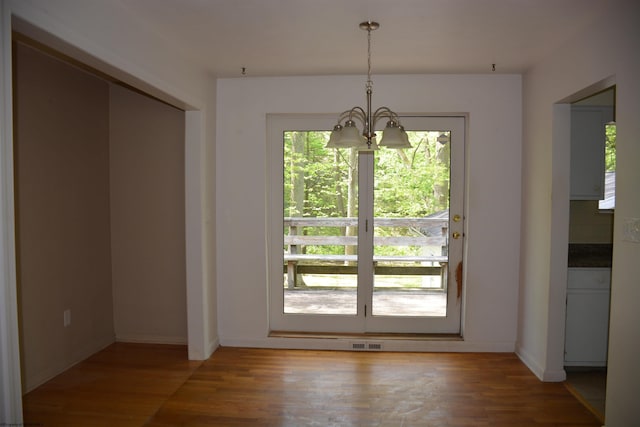 1251 Briercliff Rd, Bridgeport, WV 26330 - unfurnished dining area with light wood finished floors, a chandelier, and baseboards