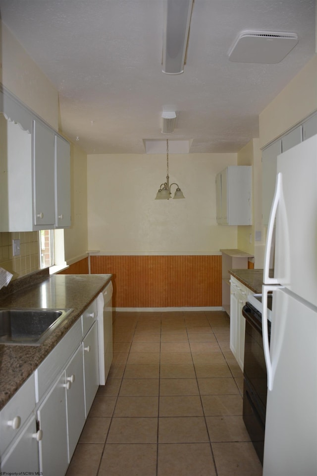 1251 Briercliff Rd, Bridgeport, WV 26330 - kitchen featuring white appliances, white cabinets, a sink, wainscoting, and light tile patterned floors