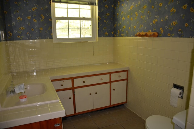 1251 Briercliff Rd, Bridgeport, WV 26330 - bathroom featuring vanity, toilet, tile walls, tile patterned flooring, and a wainscoted wall