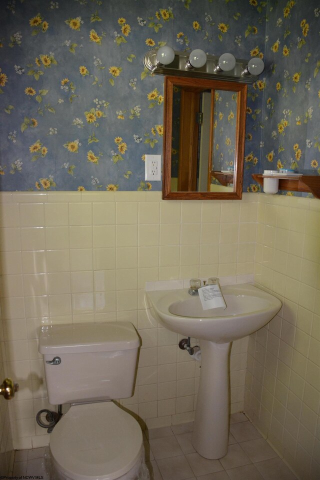 1251 Briercliff Rd, Bridgeport, WV 26330 - bathroom with tile walls, wainscoting, tile patterned flooring, and toilet