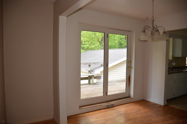 1251 Briercliff Rd, Bridgeport, WV 26330 - unfurnished dining area with a chandelier, a sink, light wood-style floors, and baseboards