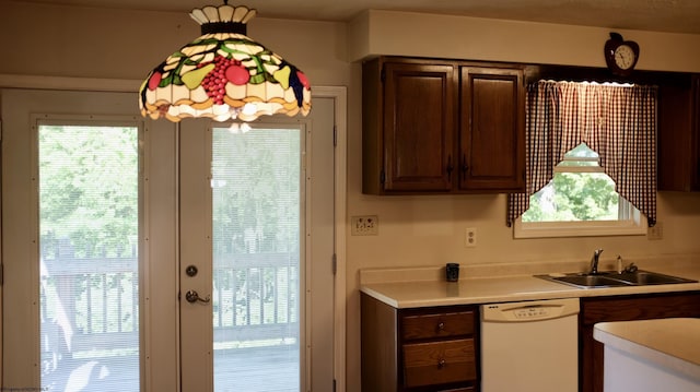 1963 Point Marion Rd, Morgantown, WV 26508 - kitchen featuring white dishwasher, a sink, light countertops, dark brown cabinetry, and pendant lighting