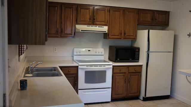 1963 Point Marion Rd, Morgantown, WV 26508 - kitchen with white appliances, under cabinet range hood, a sink, and light countertops