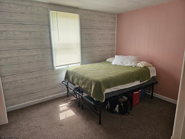 bedroom with wood walls and carpet