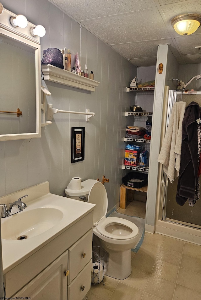 full bath featuring a stall shower, vanity, toilet, and tile patterned floors