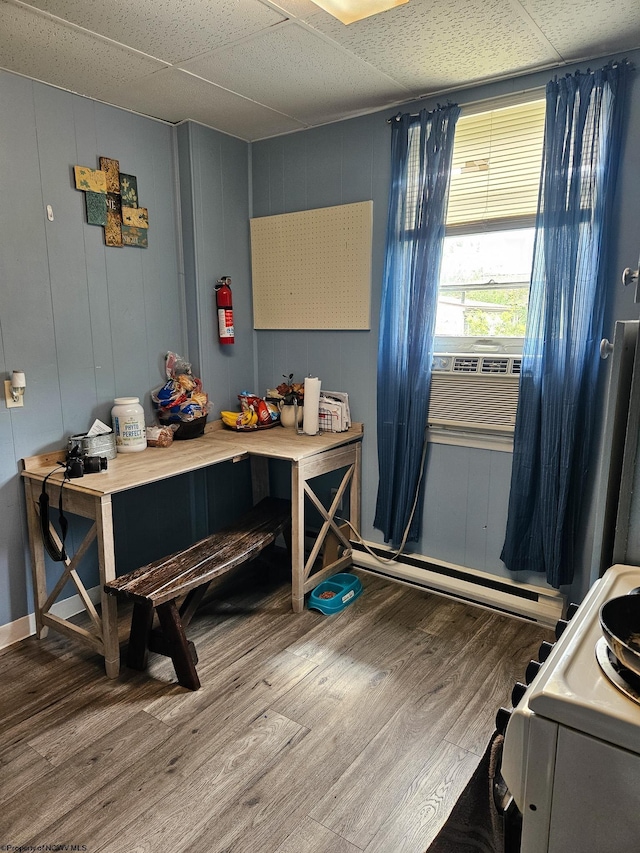 miscellaneous room featuring wood finished floors, cooling unit, a baseboard heating unit, and a paneled ceiling