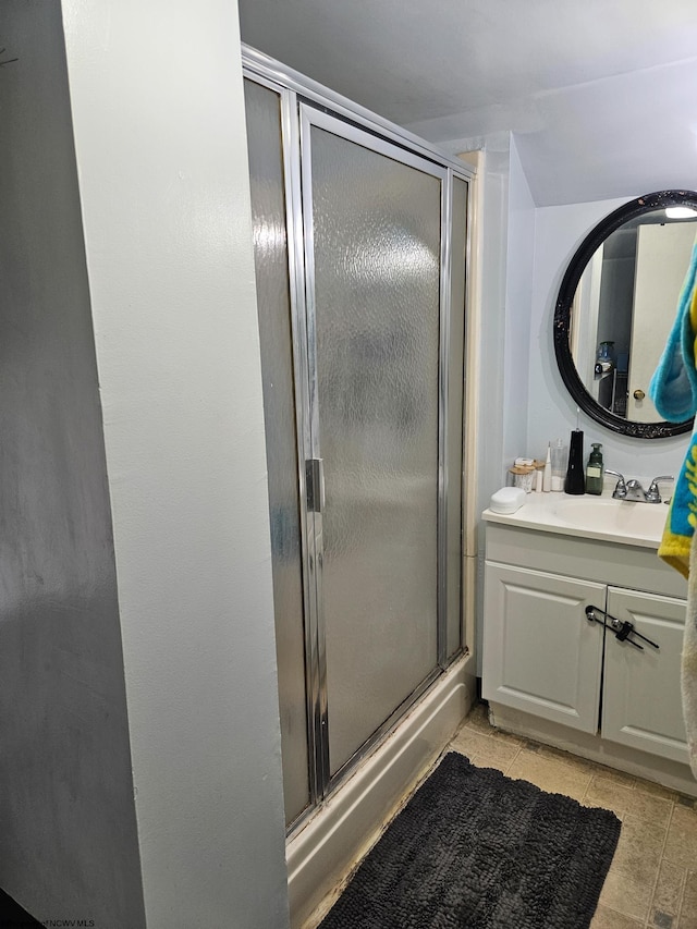 full bath featuring a stall shower, tile patterned flooring, and vanity