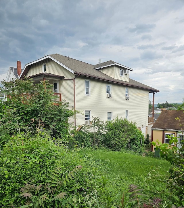 view of property exterior with a shingled roof