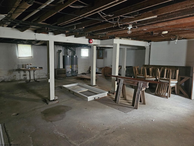 basement with plenty of natural light and gas water heater